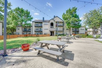 Outdoor picnic area with tables and string lights